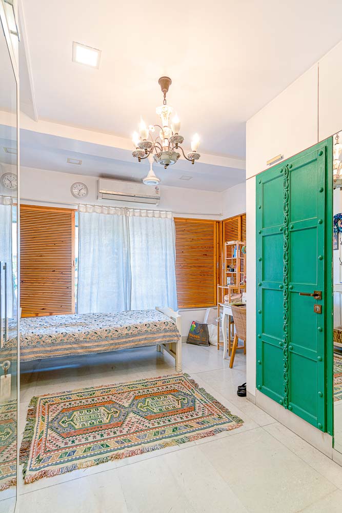 Rustic Green Door and Chandelier in the Dressing Room
